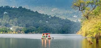Tourists enjoying boating in Goa on the Mandovi River at sunset