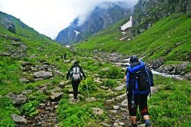 Hiking in Himachal Pradesh with trekkers exploring the scenic Triund trail in the Himalayas